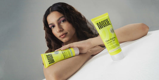 Woman with beautiful defined curls demonstrating how to maintain curly hair properly