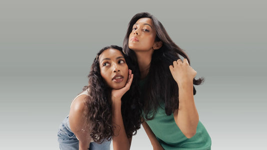 A person demonstrating proper hair brushing techniques with a wide-tooth comb in a bright bathroom.