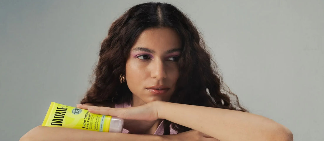 A person applying natural oil to their scalp, promoting hairline growth and healthy hair restoration.