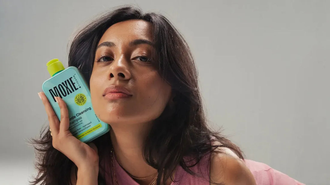 A woman applying hair serum after washing her hair for shiny, gorgeous locks.