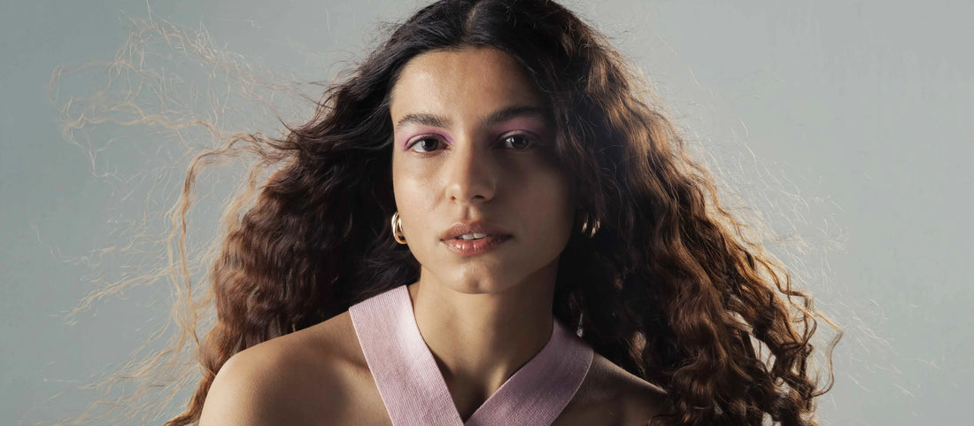 A woman with a long face showcasing various Indian hairstyles that complement her features.