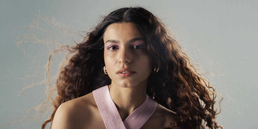 Woman with smooth, healthy hair after applying frizzy hair treatment techniques 