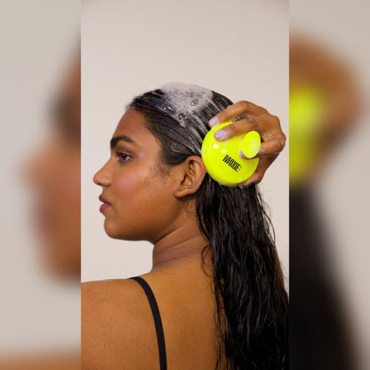 
Woman massaging her shampooed scalp with the Moxie Scalp Massager